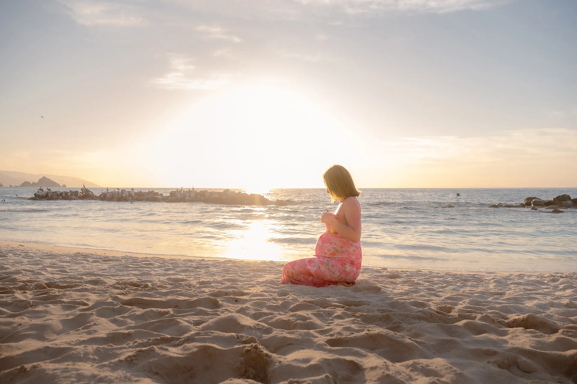 Expecting mother on a Puerto Vallarta beach at golden hour — maternity photography session
